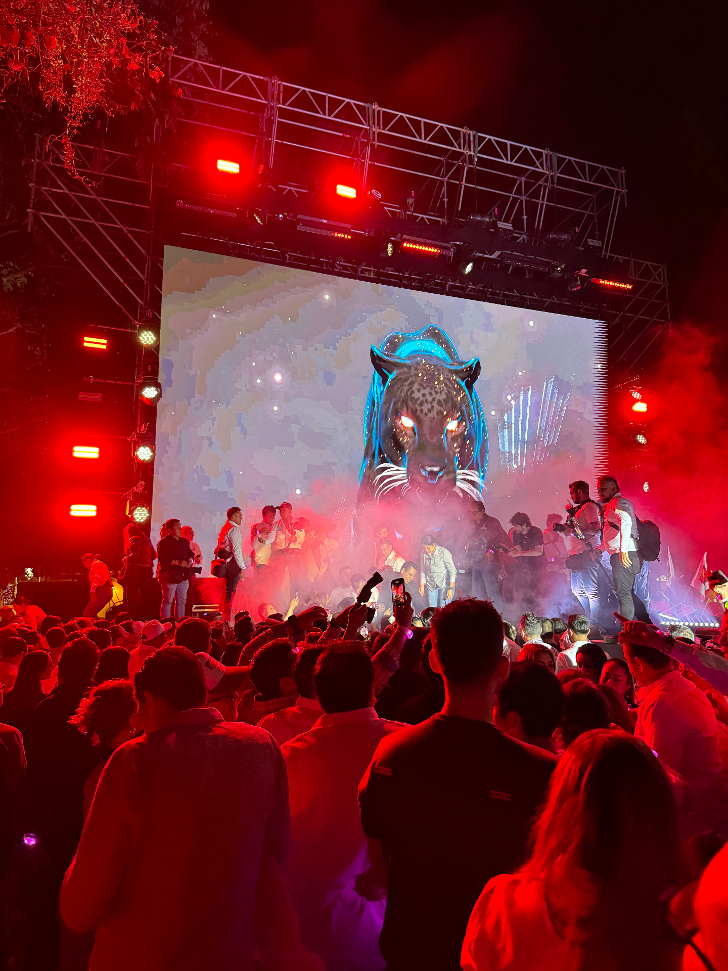 Red smoke, bright stage light and the jaguar image reaching its visual climax over the crowd.