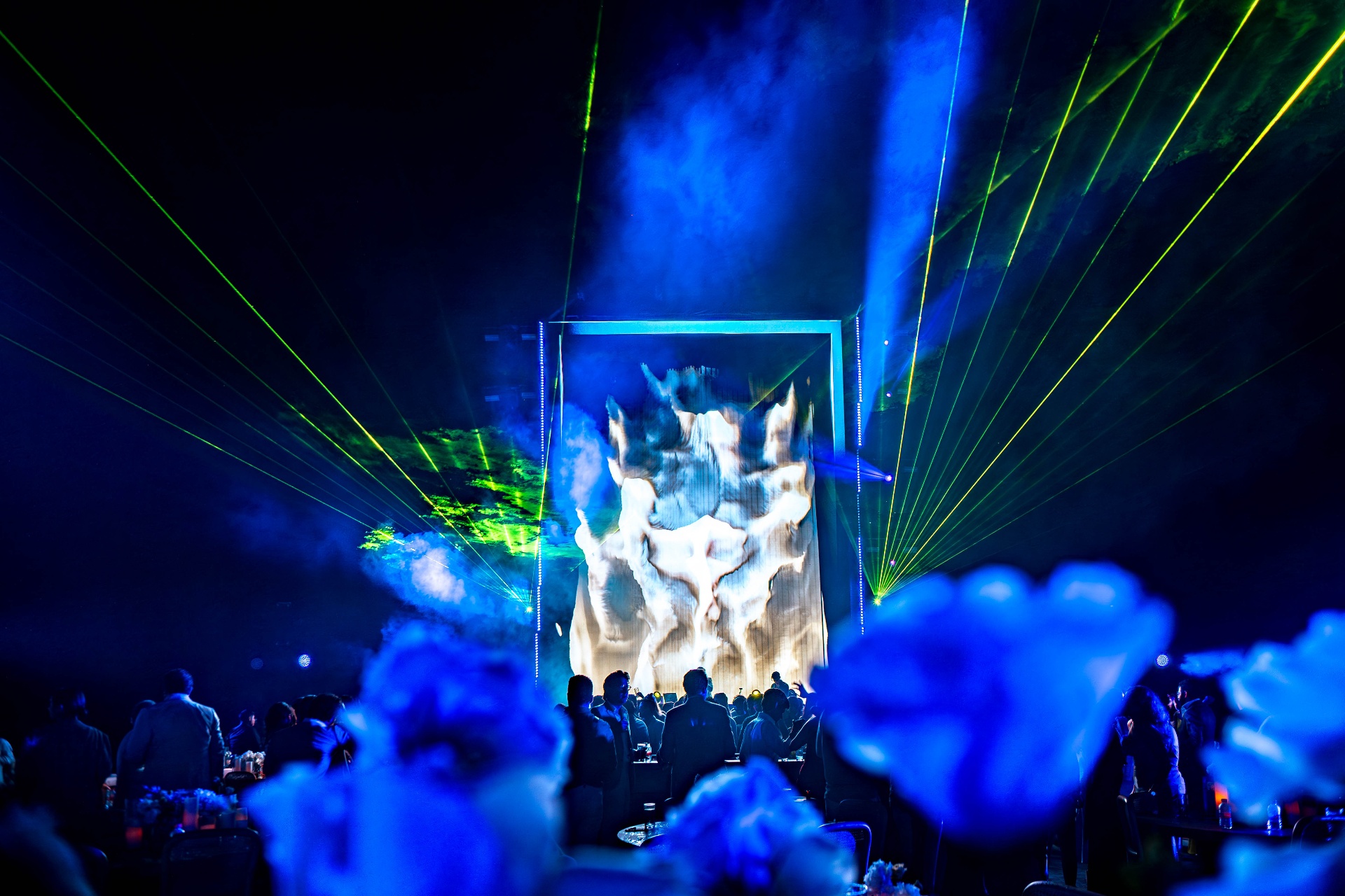 Lasers and projection mapping over the main stage at the height of the show.